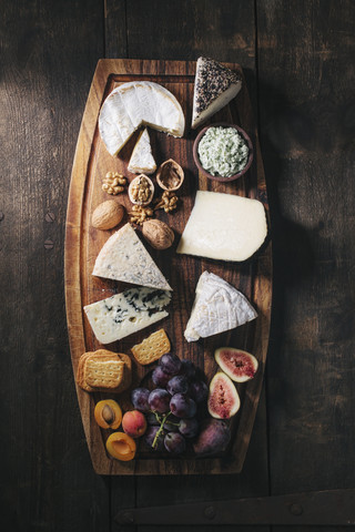 Cheese platter with fruits and nuts stock photo