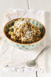 Bowl with asparagus risotto on wooden table - EVGF000205