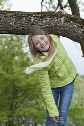 Germany, Bavaria, girl climbing on an oak - CRF002489