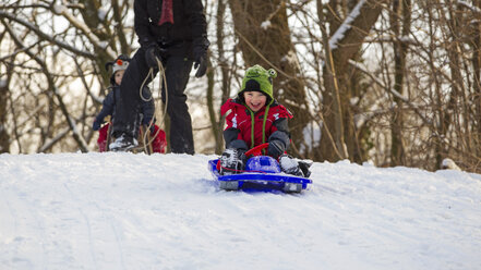 Germany, Munich, Little boy tobogganing - RDF001186