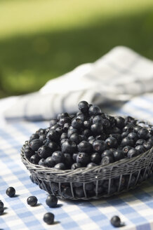 Blueberries on garden table - ASF005159