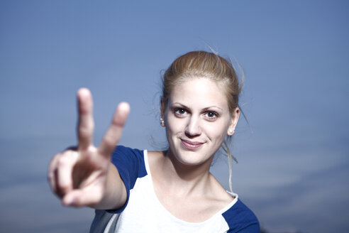 Young woman showing victory sign - FEXF000011