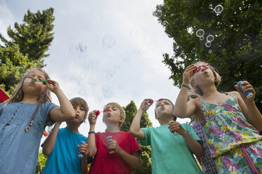 Children blowing soap bubbles - NHF001419