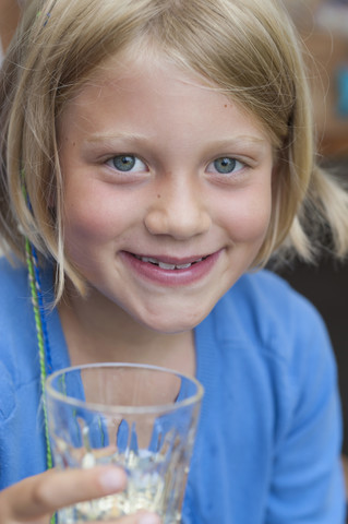 Lächelndes Mädchen mit Glas in der Hand, Porträt, lizenzfreies Stockfoto