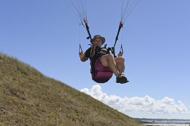 France, Bretagne, Landeda, Man paragliding - LAF000157