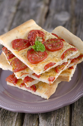 Pieces of fresh focaccia with tomatoes stock photo