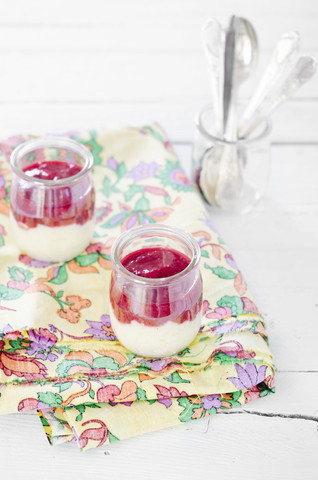 Semolina porridge with raspberry puree in glasses stock photo