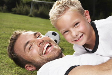 Germany, Cologne, Father and son playing soccer - PDF000400