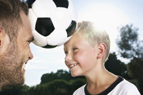 Germany, Cologne, Father and son playing soccer - PDF000410