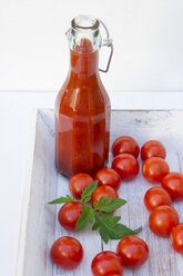 Homemade tomato sauce in wooden tray with tomatoes, close up - LVF000206