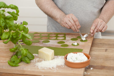 Man preparing green ravioli with ricotta - ECF000355