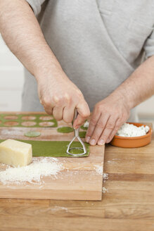 Man preparing green ravioli with ricotta - ECF000358