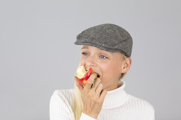 Junge Frau mit Hut isst einen Apfel - DRF000225