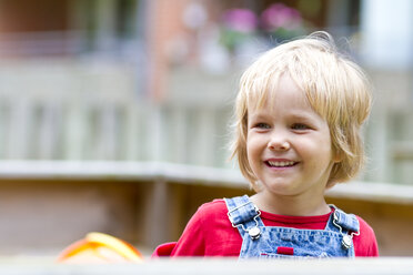 Germany, Schleswig-Holstein, Kiel, portrait of smiling little girl at playground - JFEF000231