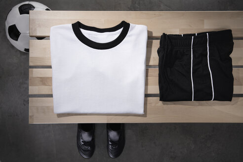 Football shirt, pants and shoes on bench, studio shot - PDF000432