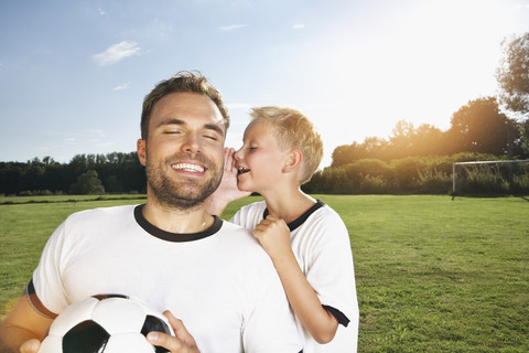 Germnay, Cologne, son whispering in father's ear stock photo