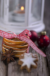 Sternanis und Orangenzeste mit Weihnachtsdekoration auf Holztisch - ODF000506