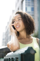 Germany, Berlin, Young women in the city, using mobile phone - FKF000240