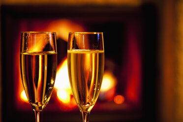 Two glasses of champagne at the fireplace - CSF020032
