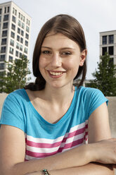 Germany, Bavaria, Munich, Smiling young woman outdoors - RBF001319