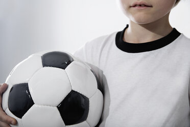 Boy in soccer jersey holding ball - PDF000468