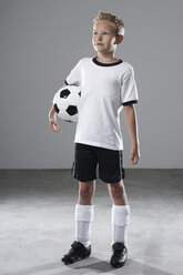 Boy in soccer jersey holding ball - PDF000485
