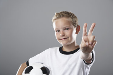 Boy in soccer jersey doing victory sign - PDF000490