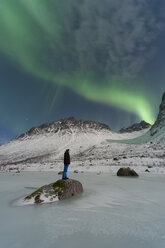 Norway, Province Troms, View of Aurora Borealis and a man - PA000042