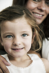 Portrait of little girl with her mother in the background - JATF000386