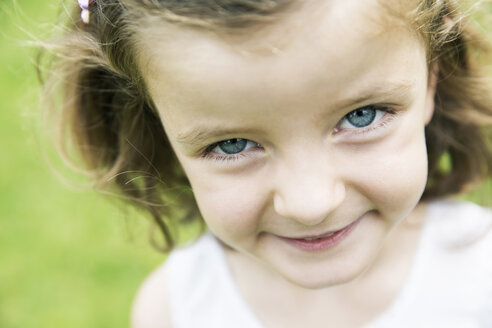 Lächelndes kleines Mädchen mit blauen Augen schaut in die Kamera - JATF000413