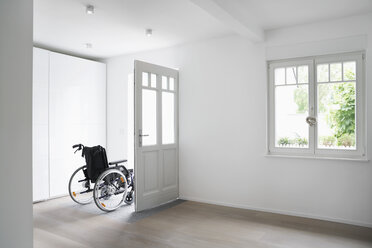 Germany, Cologne, Wheel chair in empty room - PDF000521