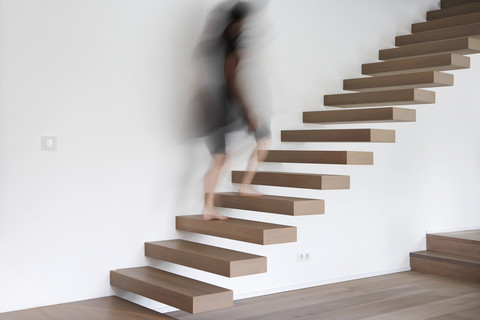 Germany, Cologne, Woman on stairs stock photo