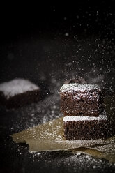 Brownies on baking paper with icing sugar - SBDF000289