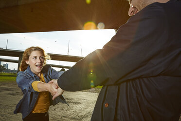 Germany, Dusseldorf, Young couple holding hands - STKF000444