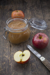 Apple puree in bottling jar and apples on wooden table - LV000274