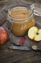 Apple puree in bottling jar and apples on wooden table - LV000273