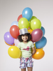 Smiling girl with balloons wearing top hat - FSF000047
