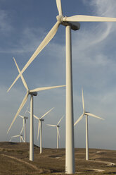 Spain, Andalusia, Cadiz, wind turbines standing on a field - KBF000001