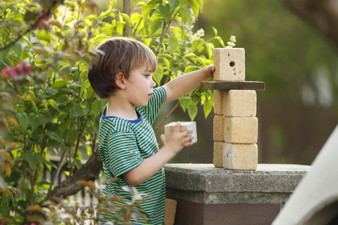 Portrait of little boy playing with wooden cubes stock photo