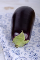 Eggplant on patterned fabric, studio shot - ODF000642