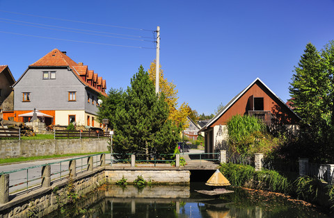 Germany, Saxony, Hinterhermsdorf, Houses at a pond stock photo