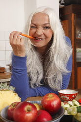 Germany, Dusseldorf, Senior woman eating raw food - UKF000250