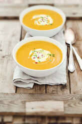 Two bowls of pumpkin soup on wooden tray, studio shot - CZF000111