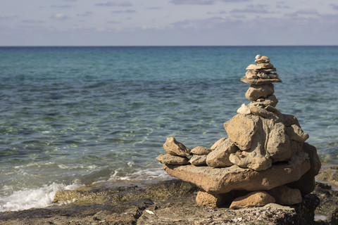 Spain, Formentera, pyramide made of stones at Playa de Migjorn stock photo