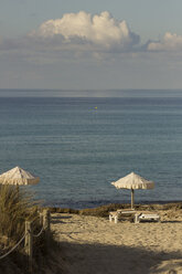 Spain, Formentera, Es Arenals, sunshades and beach chairs - CM000012