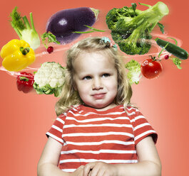 Little girl with flying vegetables around her head, Composite - STKF000493