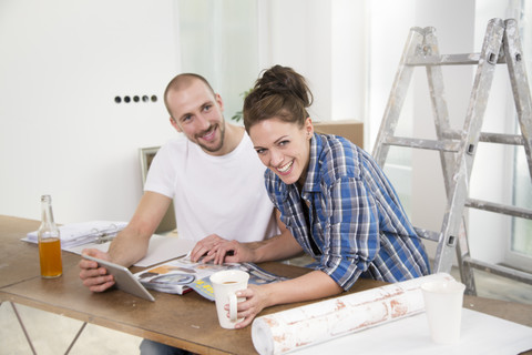 Junges Paar zieht in ein neues Haus und macht eine Pause, lizenzfreies Stockfoto