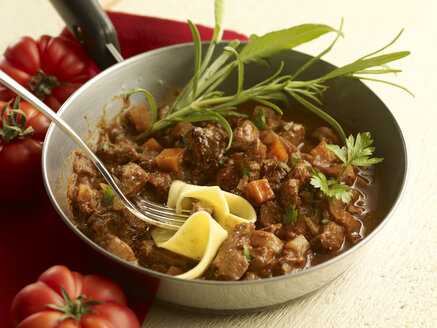 Wild boar stew with pappardelle in pan - SRSF000360