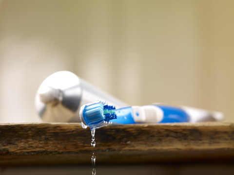 Wet toothbrush and tooth paste stock photo