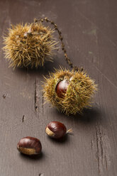 Sweet chestnuts on wooden table - MY000083